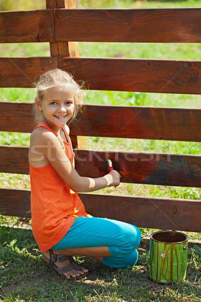 Young girl painting a wooden fence Stock photo © ilona75