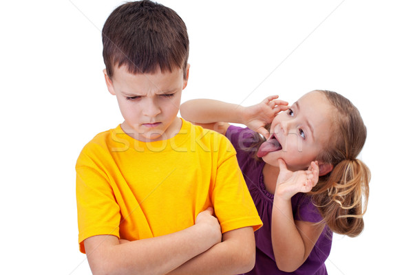 Young girl mocking boy - isolated Stock photo © ilona75