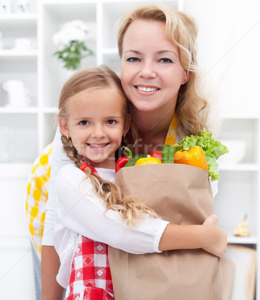 Stock photo: Little girl and woman with the groceries
