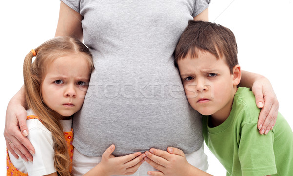 Stock photo: Grumpy kids not happy about their new sibling