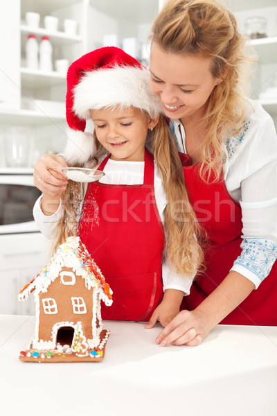Happy woman and little girl making gingerbread house Stock photo © ilona75