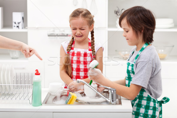 Do the dishes - kids ordered to help in the kitchen Stock photo © ilona75