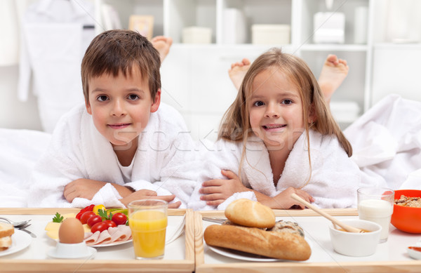 Kids having a healthy breakfast in bed Stock photo © ilona75