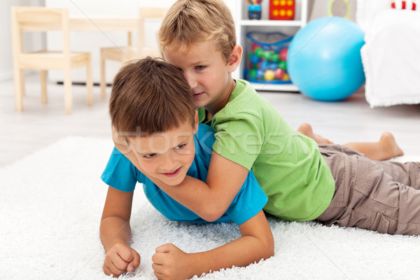 Kids wrestling on the floor Stock photo © ilona75