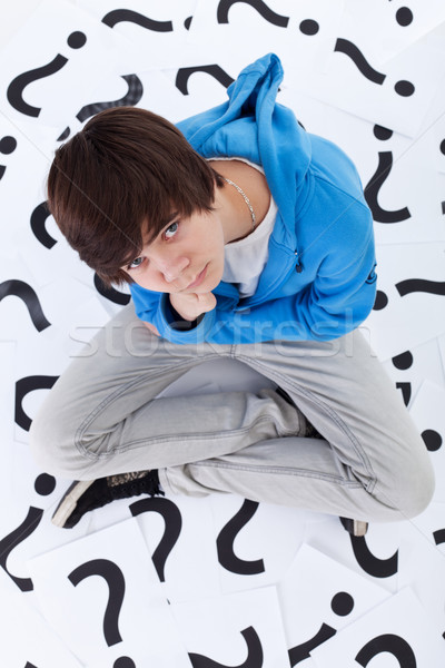 Young teenager boy with lots of questions Stock photo © ilona75