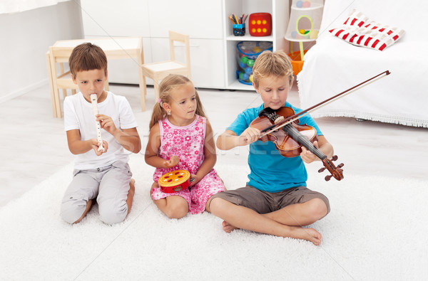 Kids trying to play on different musical instruments Stock photo © ilona75