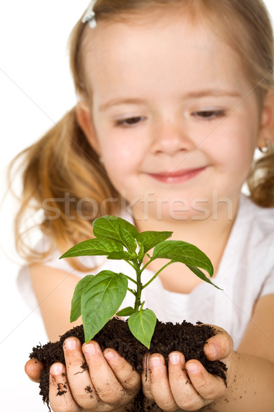 Happy little girl holding a new plant with soil Stock photo © ilona75