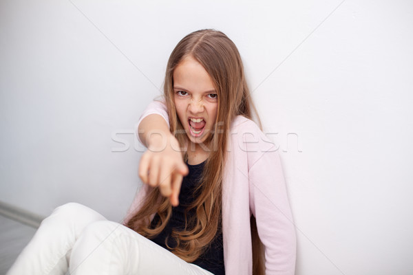 Young teenager girl having a bad day - shouting and pointing at  Stock photo © ilona75