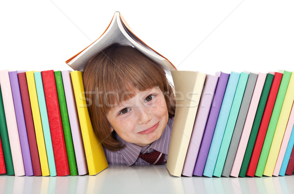 Mischievous kid with freckles and books Stock photo © ilona75