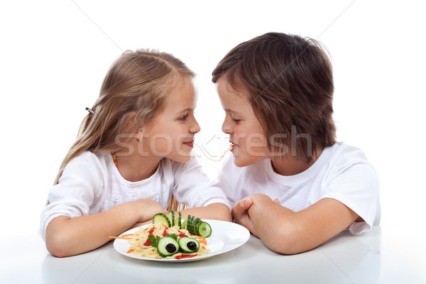 Kids sipping on the same string of pasta Stock photo © ilona75