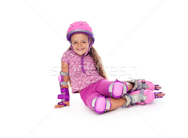 Stock photo: Little girl with roller skates resting