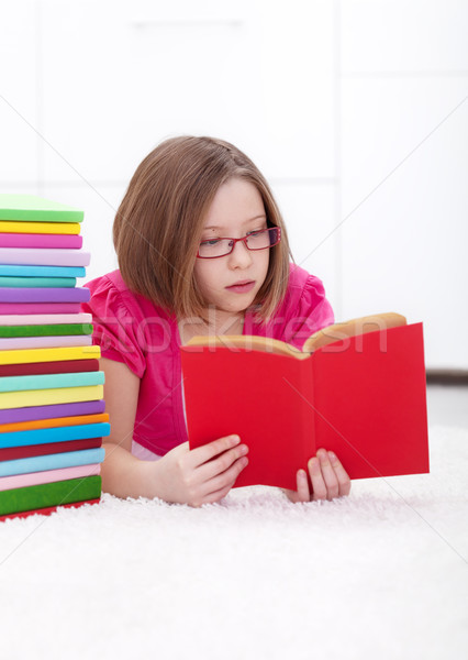 Young girl absorbed by reading Stock photo © ilona75