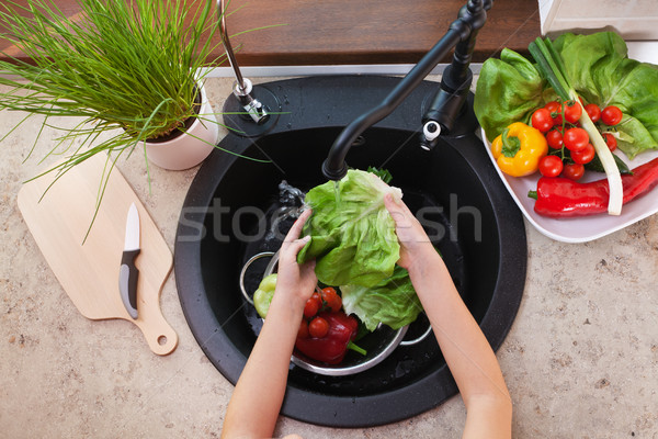 Stock photo: Child hands washing vegetables at the kitchen sink - the lettuce