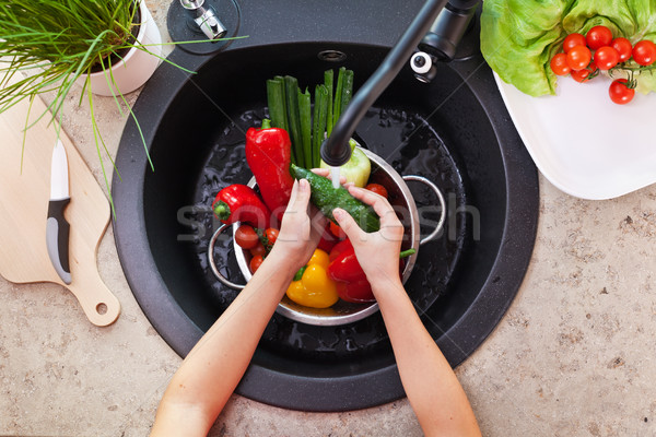 Stock photo: Child hands washing vegetables at the kitchen sink - the cucumbe