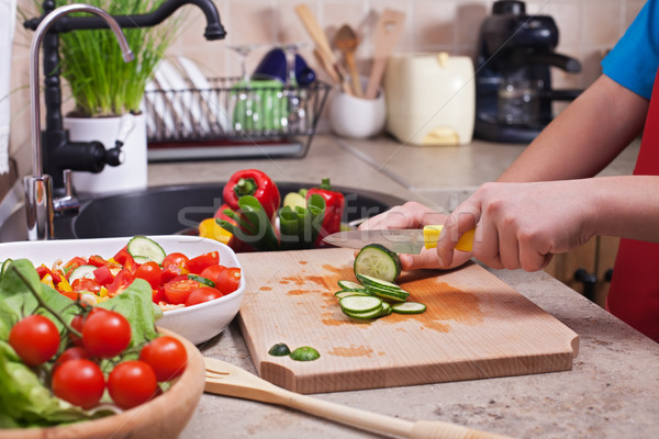 Stock photo: Child hands chopping vegetables on cutting board - slicing the c
