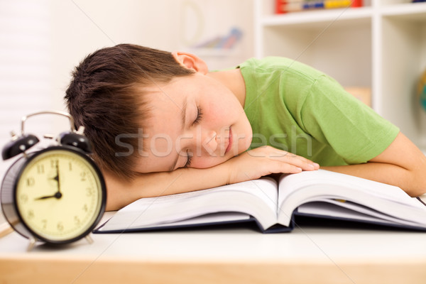 Boy fallen asleep on his book while studying Stock photo © ilona75