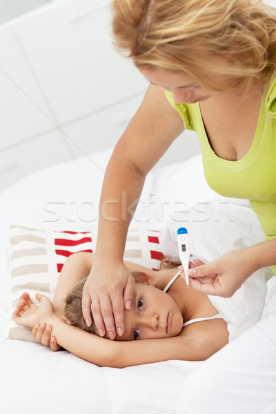 Mother checking kids temperature Stock photo © ilona75