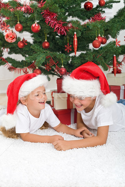 Laughing kids in front of the christmas tree Stock photo © ilona75