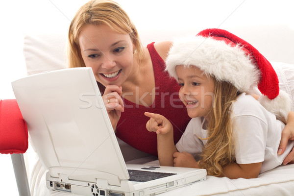 Kadın küçük kız oynama dizüstü bilgisayar Noel zaman Stok fotoğraf © ilona75