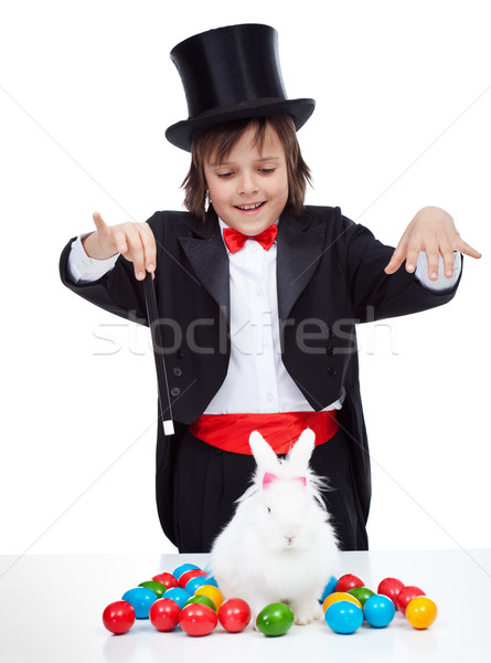 Young magician boy performing an easter trick Stock photo © ilona75