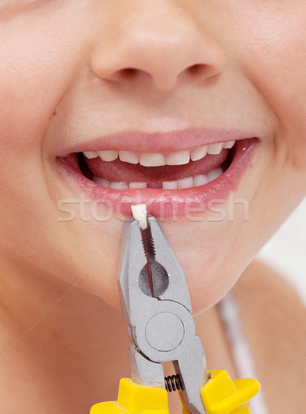 Kid with pliers holding a lost tooth - closeup Stock photo © ilona75