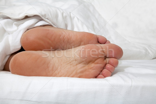 Feet in bed Stock photo © Imagecom