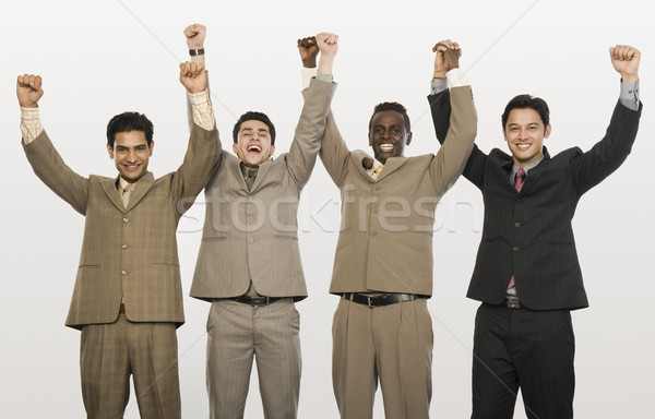 Portret cztery biznesmenów działalności trzymając się za ręce Zdjęcia stock © imagedb