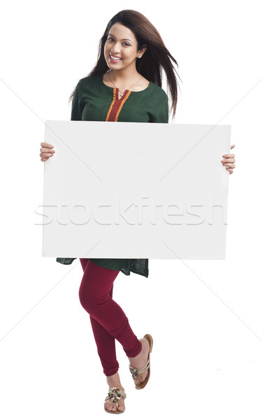 Portrait of a happy woman holding a whiteboard Stock photo © imagedb