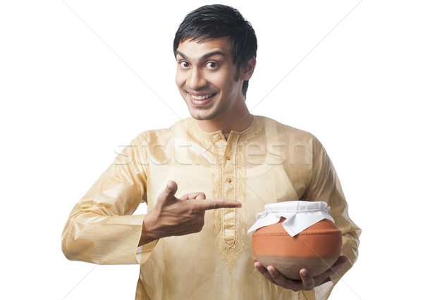 Bengali man pointing towards a pot of rasgulla Stock photo © imagedb