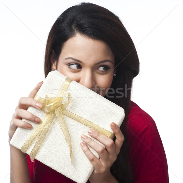 Close-up of a happy woman holding a gift box Stock photo © imagedb