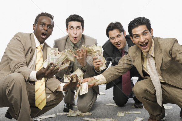 Portret vier zakenlieden hurken valuta Stockfoto © imagedb