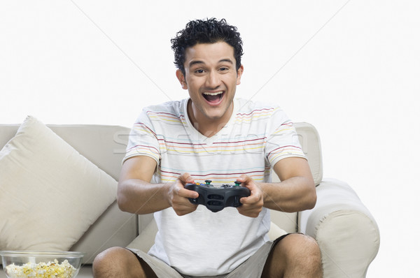 Człowiek gry gra wideo patrząc podniecony gry Zdjęcia stock © imagedb