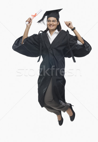 Foto stock: Mulher · saltando · diploma · graduação · vestido · preto