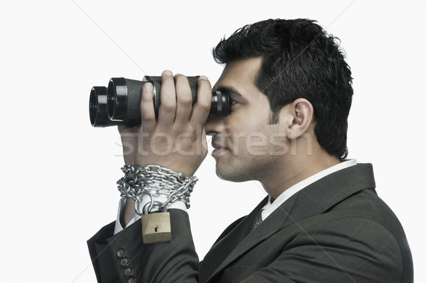 Empresario cadenas mirando binoculares negocios Foto stock © imagedb