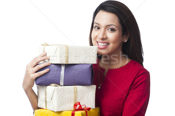 Portrait of a happy woman holding a stack of gifts Stock photo © imagedb