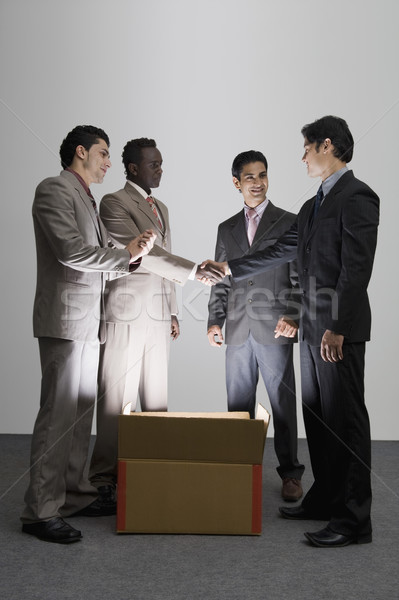 Zwei Geschäftsleute Händeschütteln beleuchtet Karton Kollegen Stock foto © imagedb