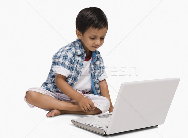 Stock photo: Boy using a laptop