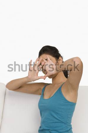 Frau Sitzung Couch Gesicht Hände Wohnzimmer Stock foto © imagedb