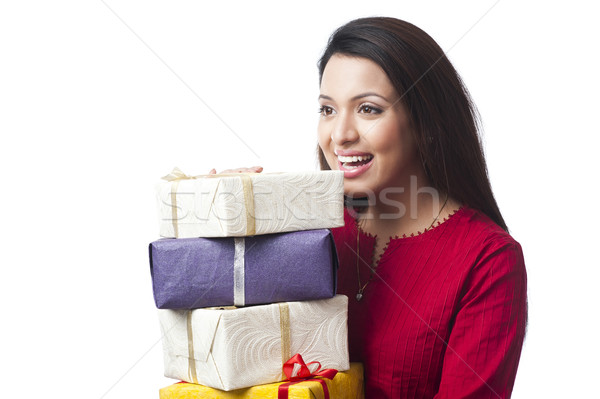 Close-up of a happy woman holding a stack of gifts Stock photo © imagedb
