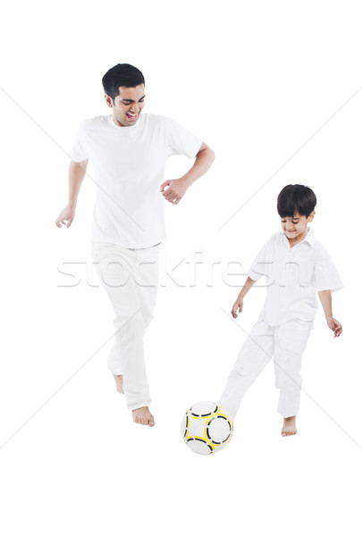 Happy father and son playing football Stock photo © imagedb