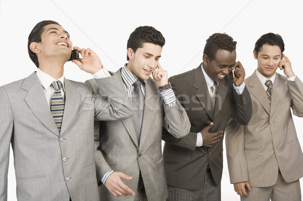 Vier Geschäftsleute sprechen Handys Business Technologie Stock foto © imagedb