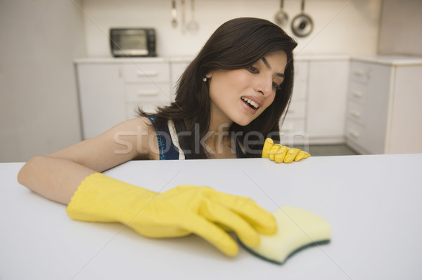 Nő takarítás konyhapult ház mosolyog boldogság Stock fotó © imagedb