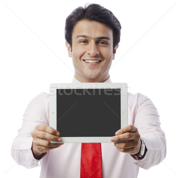 Stock photo: Portrait of a businessman showing a digital tablet