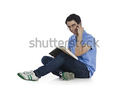 Boldog férfi beszél mobiltelefon olvas könyv Stock fotó © imagedb
