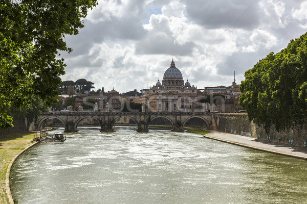 Bridge across a river with a basilica in the background Stock photo © imagedb