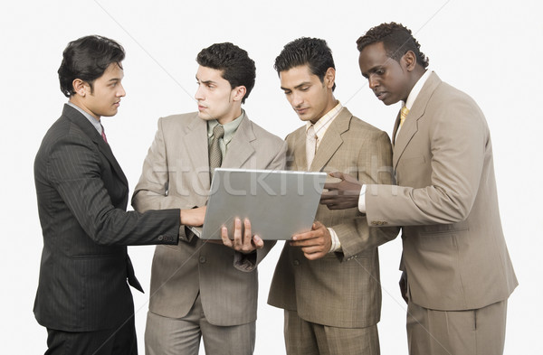 Vier Geschäftsleute stehen Laptop Business Technologie Stock foto © imagedb