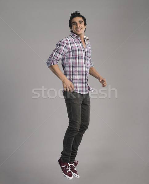 Portrait heureux homme sautant souriant isolé [[stock_photo]] © imagedb