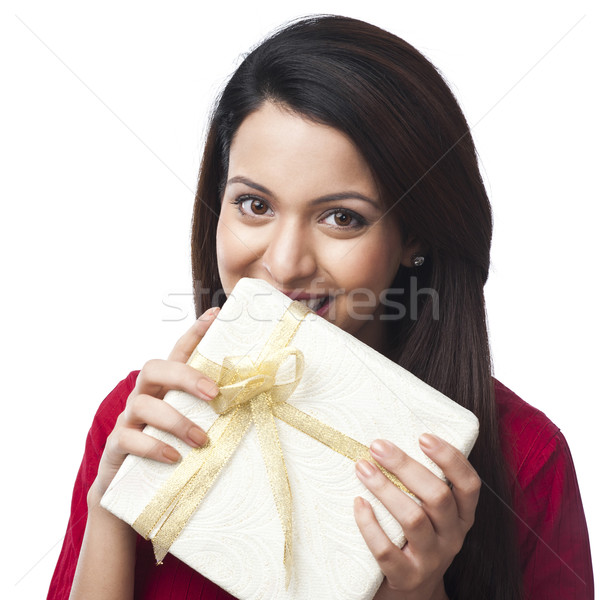 Portrait of a happy woman holding a gift box Stock photo © imagedb