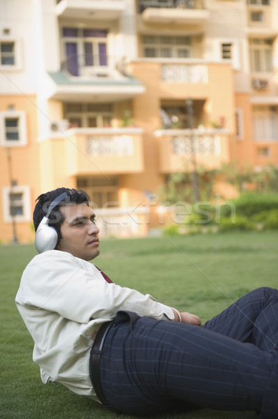 Empresario hierba escuchar música edificio hombre pelo Foto stock © imagedb
