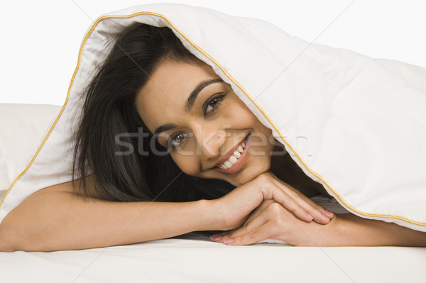 Portret kobieta patrząc kołdra młodych sypialni Zdjęcia stock © imagedb